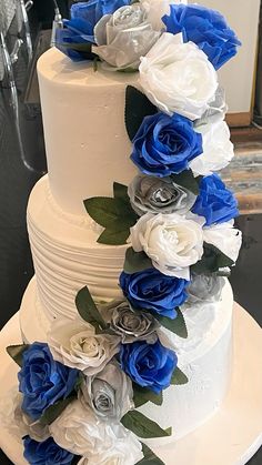 a wedding cake with blue and white flowers on it