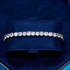 a blue velvet box with a diamond ring in it's lapel cover and the inside of its case