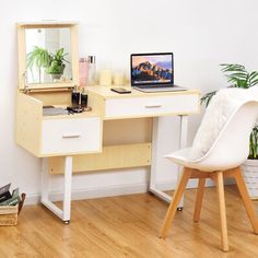 a desk with a laptop computer on top of it next to a chair and potted plant