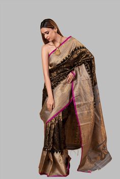 Gadwal Silk Brocade Saree in classic black, exquisitely crafted with a golden zari floral brocade across its expanse. This saree is embellished with a striking broad border of gold zari floral brocade set against a vivid pink edge. The Pallu, splendid with a contrasting gold zari floral brocade pattern, adds to its regal charm. This saree is an impeccable combination of sophistication and contemporary fashion, sure to elevate any wardrobe. Sari For Women, Black Sari, Baluchari Saree, White Embroidered Blouse, Brocade Pattern, Brocade Saree, Orange Saree, Cotton Gowns, Party Sarees