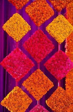 an arrangement of flowers arranged in squares on purple background with red and yellow colors for decoration