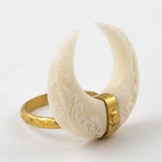 Our Golden horn ring from our Matahari Collection is hand carved bone with a unique and intricate Balinese design on the front and back... Set in silver plated in 22k gold. An elegant statement piece. different sizes available please inquire upon ordering... Carved Bone Ring, Unique Carved Yellow Gold Ring, Spiritual Carved Gold Ring, Spiritual Gold Carved Rings, Unique Carved Bone Jewelry, Unique Bone-colored Carved Jewelry, Dragons Hoard, Bone Rings, Bones Jewelry