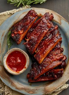 barbecue ribs and dipping sauce on a plate