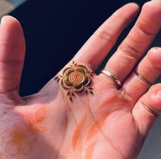 a person's hand with an intricate ring on it