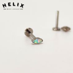 a pair of surgical steel ear studs with an opal inlay