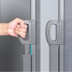 a person is opening the door with their hand and holding it in front of them