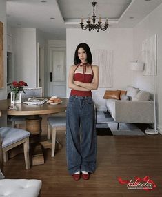 a woman standing in the middle of a living room