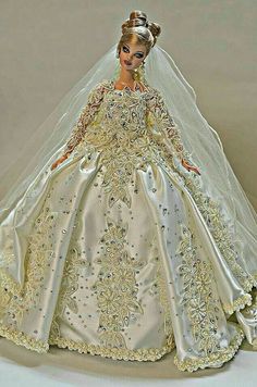 a barbie doll dressed in a wedding gown and tiara, with veil over her head