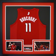 a basketball jersey is in a frame with two photos and an autographed photo