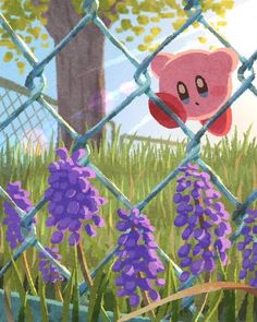 an animal in the grass behind a chain link fence with purple flowers growing through it