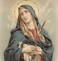 the immaculate mary holding a crucifix in her hands