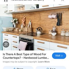 a kitchen with white cabinets and wood counter tops, including an appliance on the phone