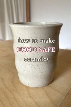 a ceramic cup sitting on top of a wooden table with the words how to make food safe ceramics