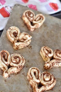 cinnamon rolls are on a baking sheet ready to be baked in the oven and eaten