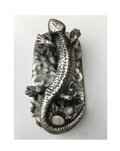 a metal object that is shaped like a lizard