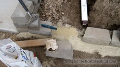 cement blocks and tools laying on the ground