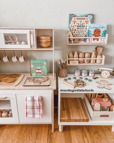 a wooden play kitchen with lots of toys