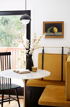 a living room filled with furniture and a painting hanging on the wall above a table