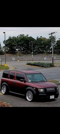 a black and red car parked on the side of the road