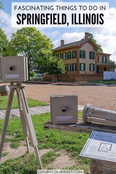 an old fashioned camera sitting on top of a tripod in front of a house