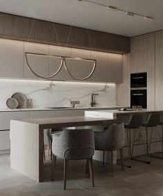 a modern kitchen with marble counter tops and bar stools