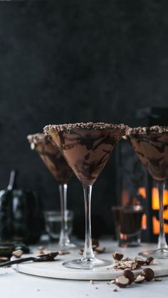 three martini glasses filled with chocolate and nuts