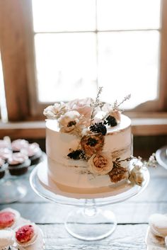 a wedding cake with flowers on top