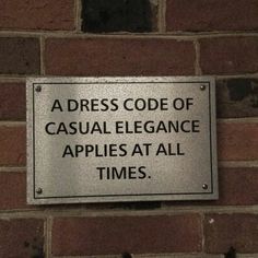 a sign on the side of a brick wall stating that it's time to dress code of casual elegance apples at all times