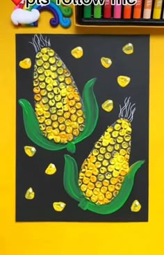 the corn on the cob is made out of plastic bottle caps and yellow glue