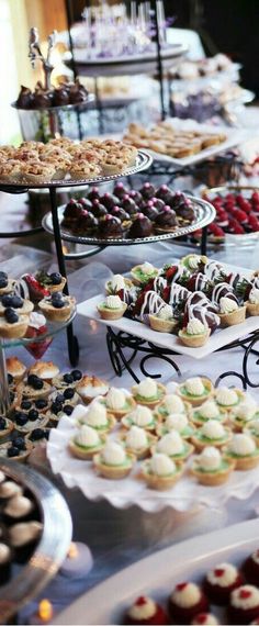 a table filled with lots of different types of desserts