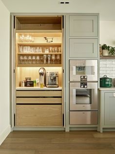 an open cabinet in the middle of a kitchen