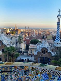 the city skyline is seen from above with colorful architecture in the foreground and palm trees on the other side