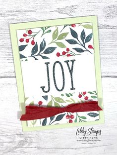 a christmas card with the word joy on it and red ribbon tied around the edge