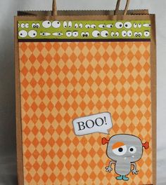 an orange and white checkered bag with a cartoon character holding a sign that says boo