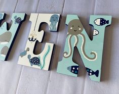 the letters are made out of wood and have an octopus, fish, and seahorse design