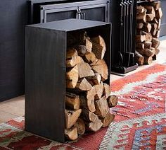 a fireplace with logs stacked on top of it in front of a firewood rack