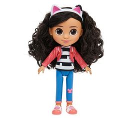 a doll with long black hair wearing blue pants and a cat ear hat, standing on a white background