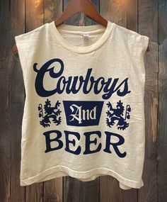 Country Deep Cowboys and Beer Logo Boxy Cropped muscle top 6 oz./yd², 100% cotton, garment-dyed, 18 singlesGarment-dyed for that vintage, faded look and almost no shrinkage at homeBoxy fit, slightly croppedWide rib collarTaped neck and shoulders for comfort and durabilityStructured shoulders Body Length 20 21 22 23 24Body Length Tolerance +/-1 +/-1 +/-1 +/-1 +/-1Chest Tolerance +/-1 +/-1 +/-1 +/-1 +/-1Chest Width (Laid Flat) 21 22 23 24 1/2 26 Cowboy Apparel Men, Concert Outfit Country, Western Graphic Tees, Beer Logo, Baby Crop Top, Distressed Tee, Sweatshirt Short Sleeve, Beer Shirts, Crew Sweatshirts