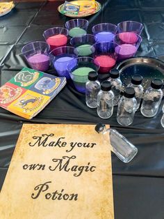 there are many cups on the table with some writing on it and an empty sign that says make your own magic potton