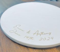 a white plate with writing on it sitting on a table