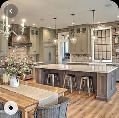 a large kitchen with wooden floors and gray cabinets