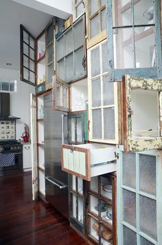 an old kitchen with lots of windows and cupboards in the wall next to it