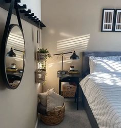 a bedroom with a bed, mirror and two lamps on either side of the bed