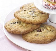 cookies and doughnuts are stacked on a white plate