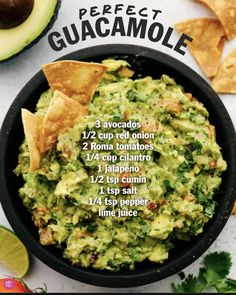 a bowl filled with guacamole next to tortilla chips and an avocado