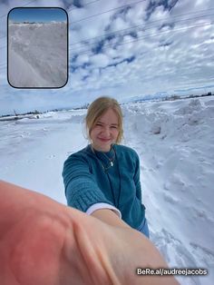 a woman is holding out her hand in the snow