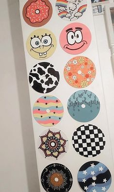 an open refrigerator door covered in magnets with cartoon faces and doughnuts on them