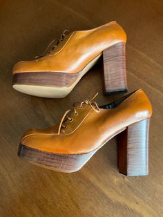 1970s L.G. Haig platform shoes.  Tan leather uppers. Brass tone grommets. Leather laces. Stacked wood look heel and sole. Vinyl soles. Size 7B Measurements  9" length 3" width 4" heel rise 1" sole rise Fun shoes show very well exhibiting very minimal wear.  Deadstock item having never been worn. A couple minor "scratches" on the toe tips. 1970 Shoes Women, Retro Round Toe Platform Heels, Retro Platform Heels With Round Toe, Vintage High Heel Shoes With Rubber Sole, Retro Chunky Platform High Heels, Retro Heels With Chunky Platform, Vintage High Heels With Rubber Sole, Retro Chunky Platform Heels, Vintage High Heel Platform Heels