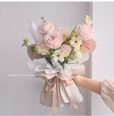 a bouquet of flowers is being held by someone