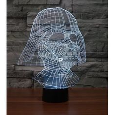 a 3d image of darth vader helmet on a table with a brick wall in the background